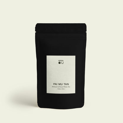 Verpackung des Pai Mu Tan Tees mit Etikett, das die hochwertige Herkunft aus den Hochlagen von Fujian, China, widerspiegelt.

Packaging of Pai Mu Tan Tea with label, reflecting the high-quality origin from the highlands of Fujian, China.